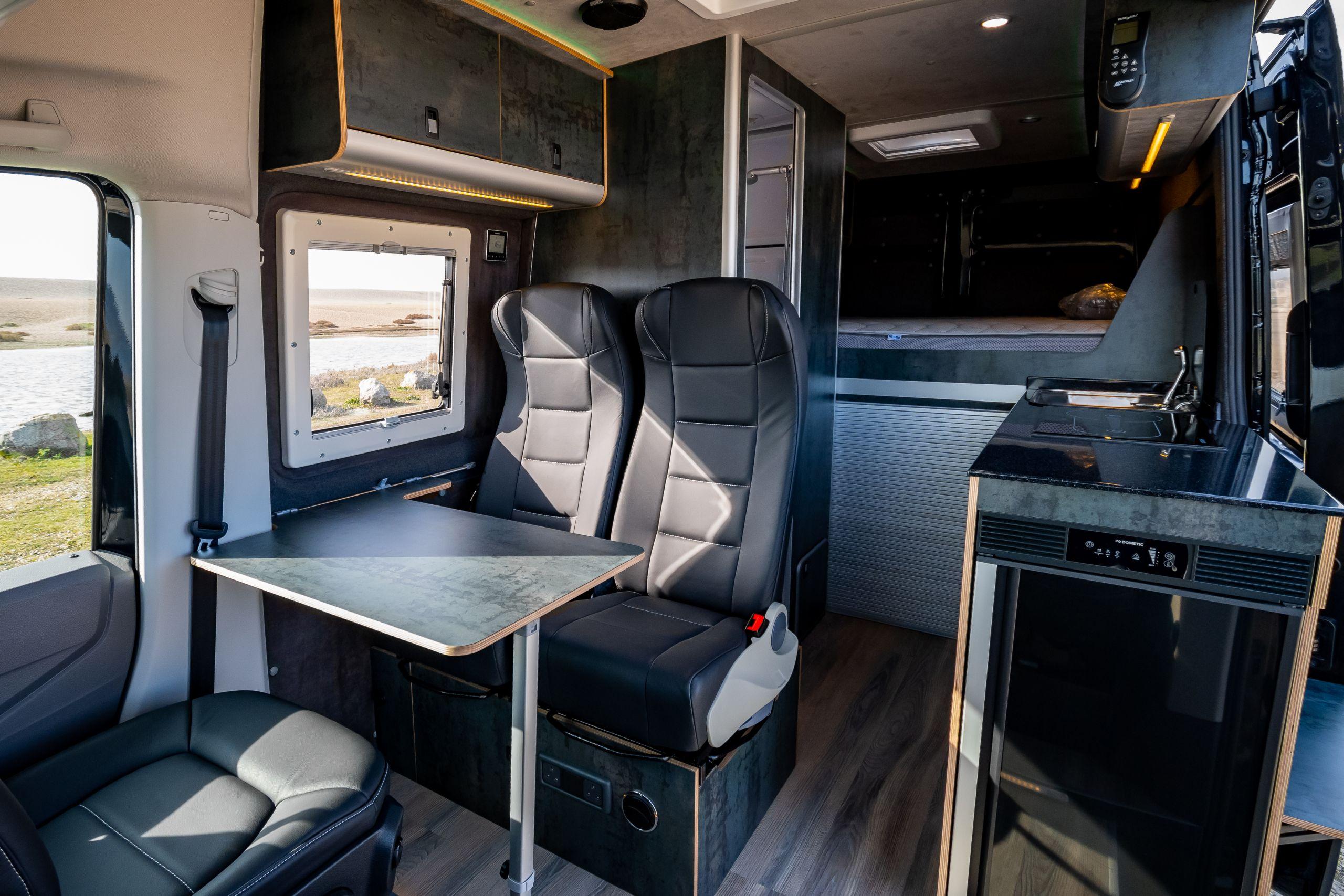 The Maxtraxx 4x4 Off-Grid Camper Conversion By Vanworx, Is The Ultimate Zombie Escape Vehicle! 5 inside of campervan showing seating area and kitchen