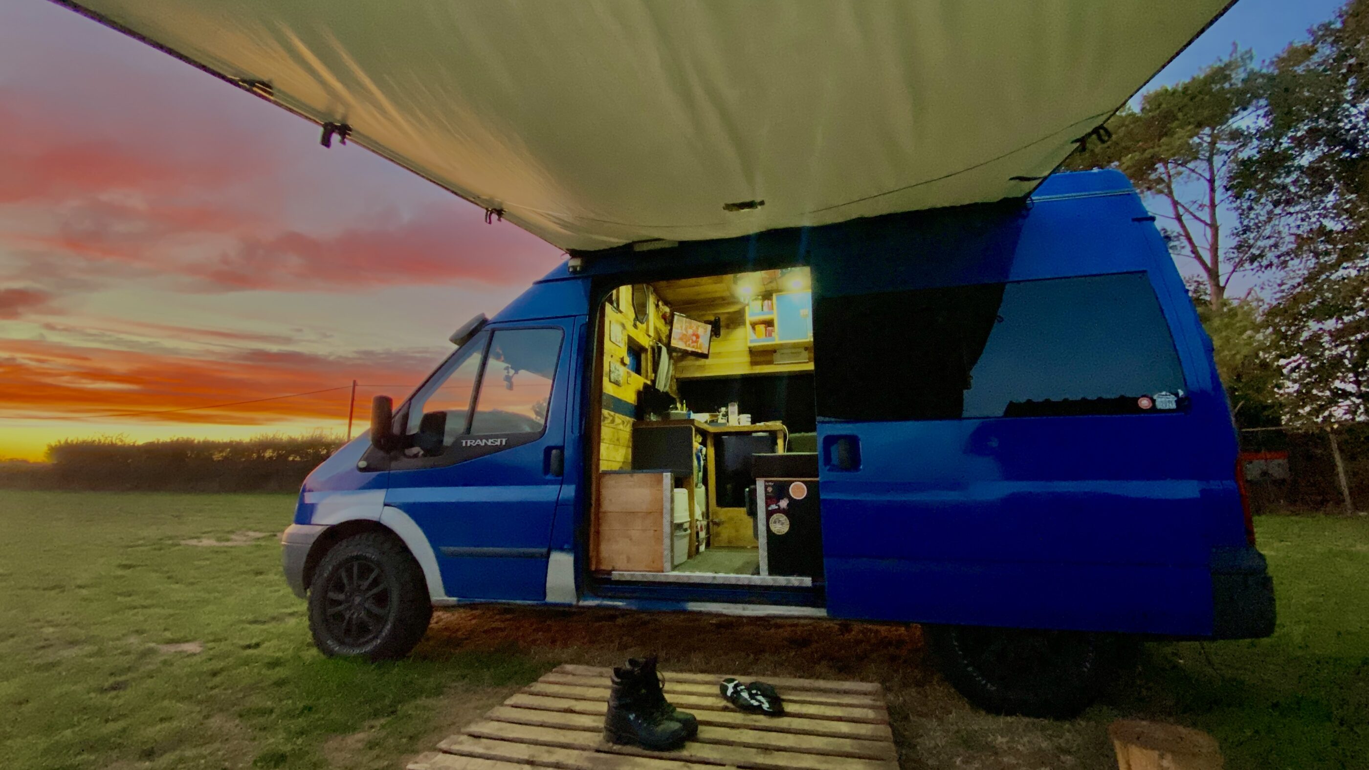 calamity shane vanlife through the side door of a blue van